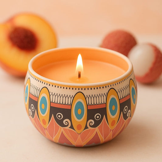 Burning vegan natural candle in decorative bowl with peach and lychee fruits in soft background