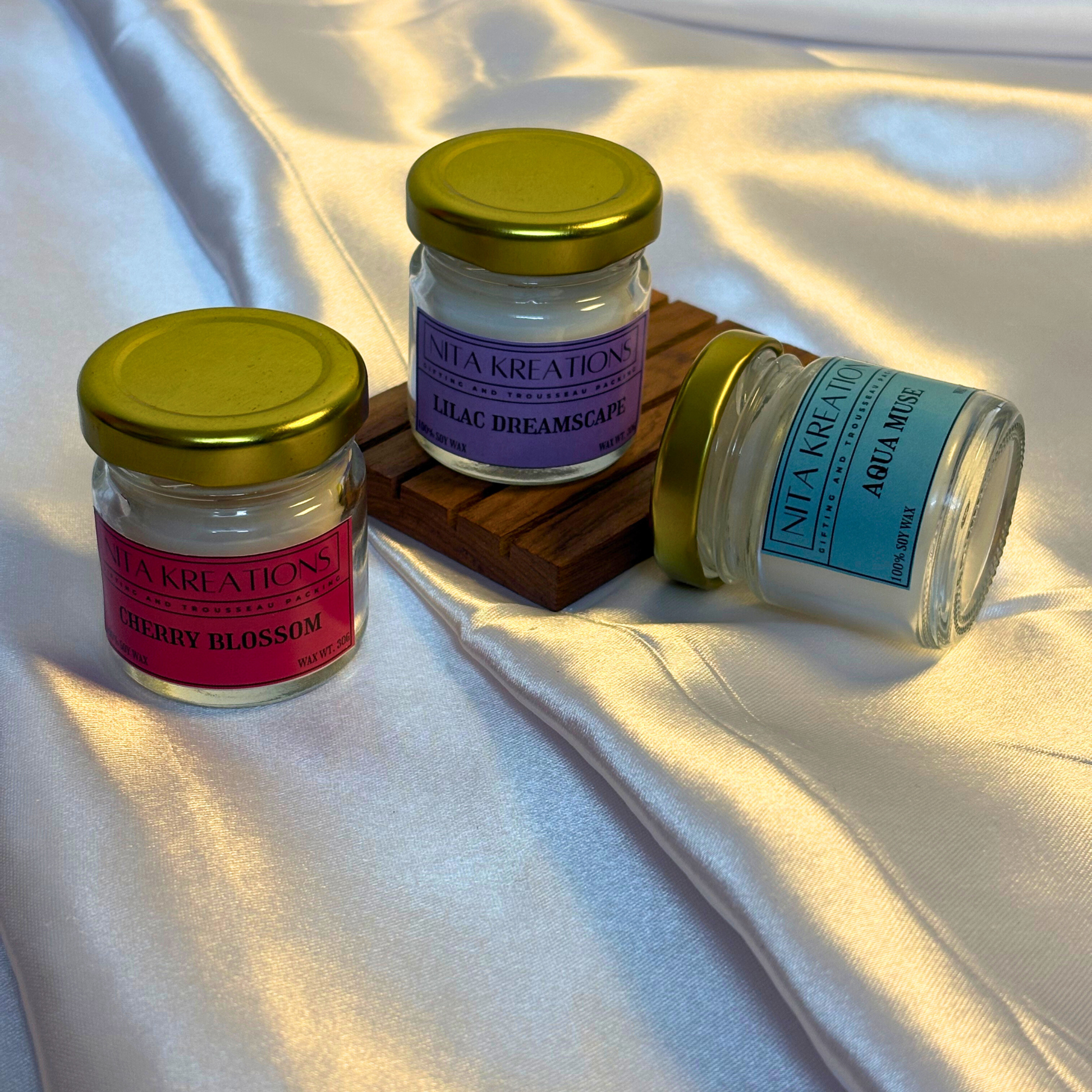 Pack of 3 mini soy wax candles in amber jars featuring Lilac Dreamscape, Aqua Muse and Cherry Blossom fragrances, named Blossoms of Seoul.