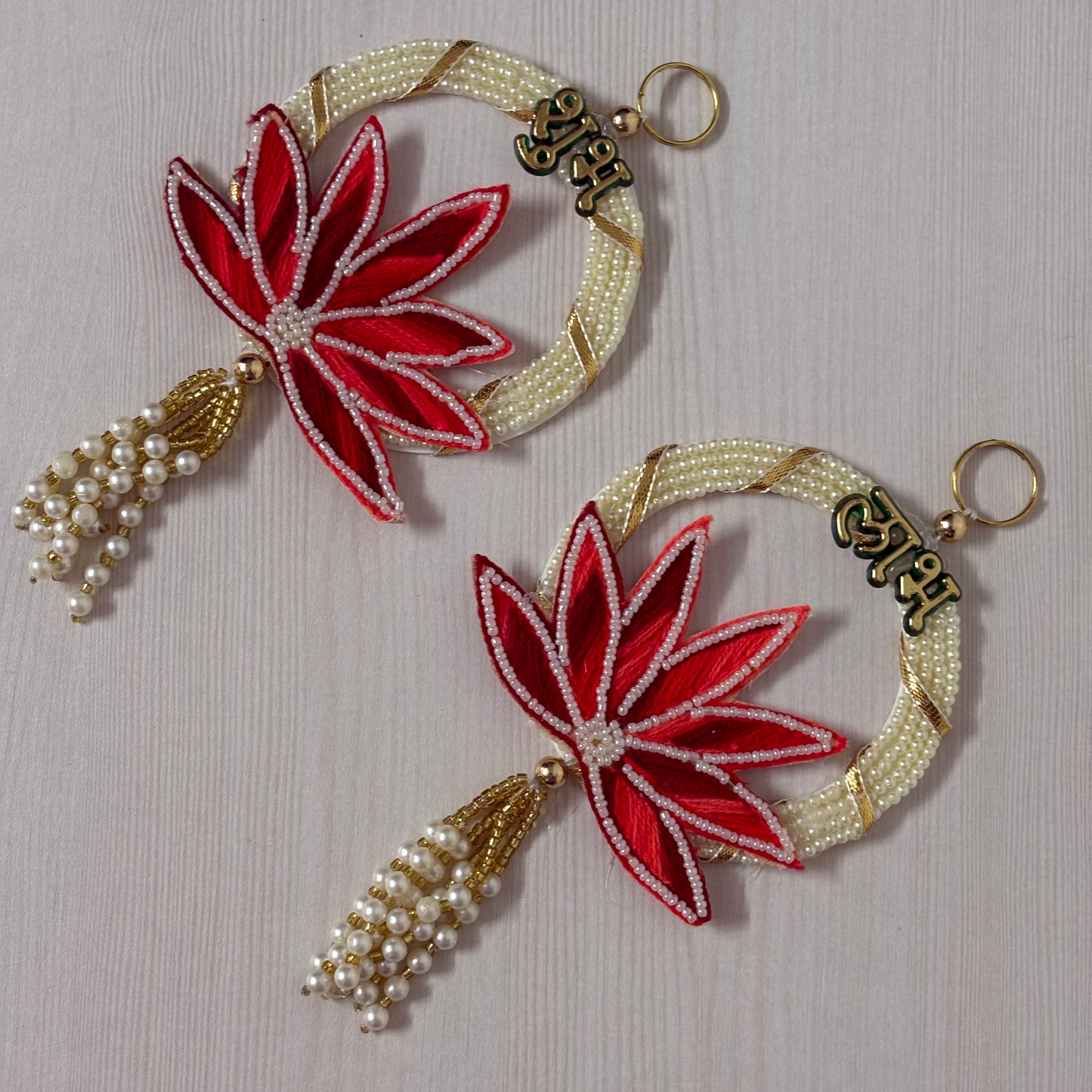 Handcrafted Shubh Labh wall hanging pair with lotus embroidery, pearl beads, and tassels for Diwali home decoration. Shubh Labh, Ganpati, home decor, house warming gifts, diwali, diwali home decore, wedding gifts, gifts, corporate gifting, gifts under 500, gifts under 1000, festive gifting.