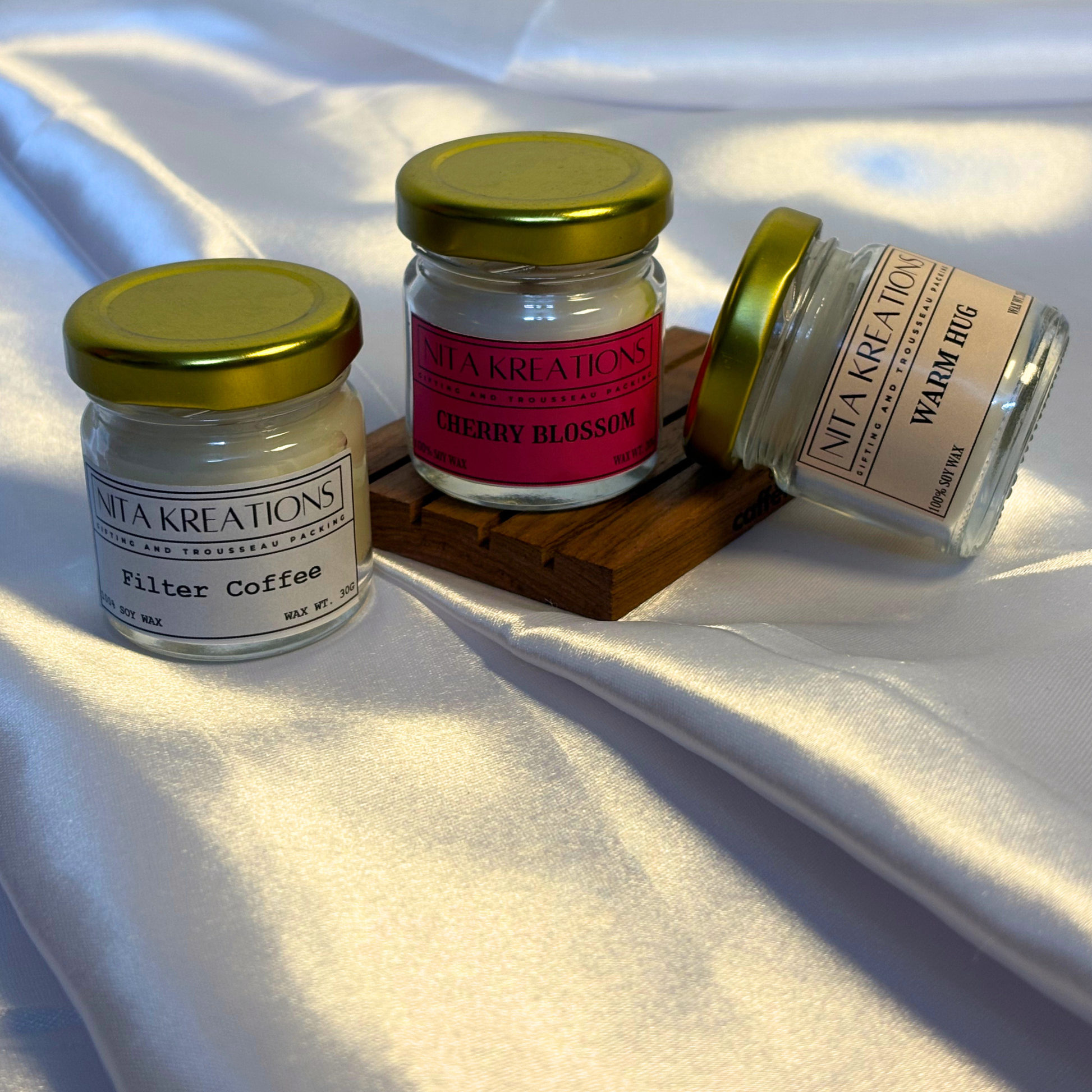 Pack of 3 mini soy wax candles in amber jars featuring Warm Hug, Filter Coffee and Cherry Blossom fragrances, named Slow Morning Warmth.