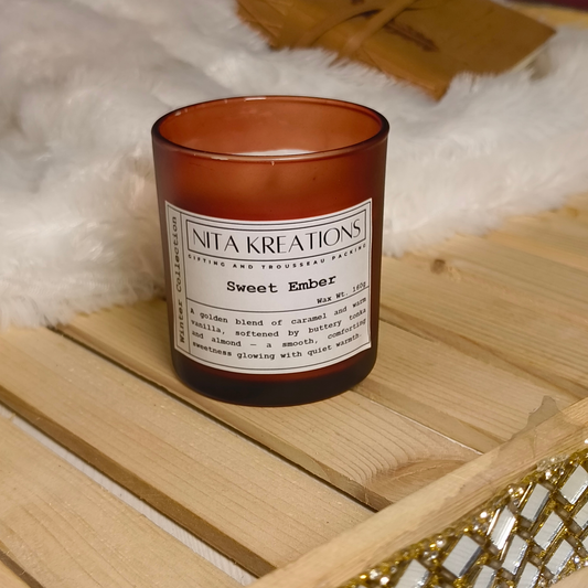 Soy wax candle in amber jar with wooden lid, Sweet Ember fragrance with caramelized vanilla and toasted tonka.