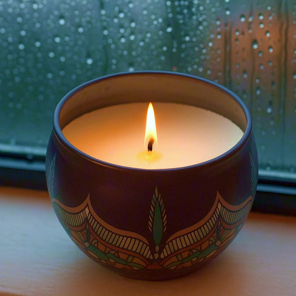 Candle in a decorative bowl with a green pattern on a windowsill. Candle in a decorative container with two water lilies on a light background, bbw candles, candles, vegan candles, decorative candles, soy-wax candles, jo malone, home decor, ganpati decoration, diwali gift, rakhi gift for sister, gilli mitti candle

